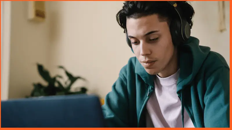 young man learning while listening to music