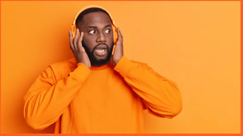 man in shock listening to audiobook