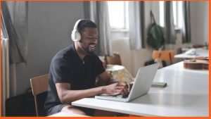 black man listening to music while studying.